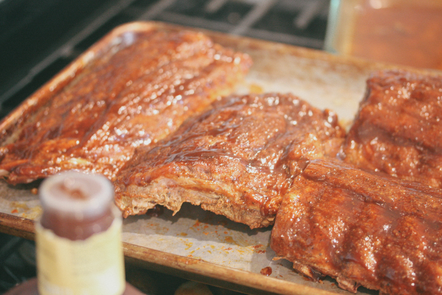 After 2.5 hours pull the ribs out of the oven and brush with BBQ sauce