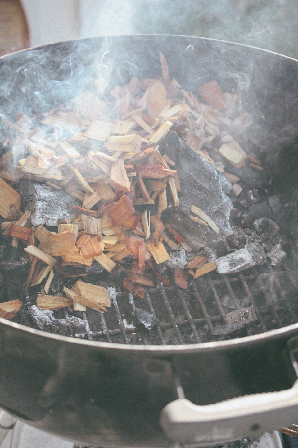 Pour the coals to one side of the Weber and place the wood chips on top of the coal